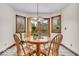 Bright dining nook with charming wood table set and large windows at 7113 Lakeside Woods Dr, Indianapolis, IN 46278
