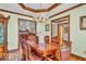 Elegant dining room with ornate wood table and chairs, and hardwood flooring at 7113 Lakeside Woods Dr, Indianapolis, IN 46278