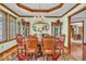 Formal dining room featuring hardwood floors, crown molding, and elegant chandelier lighting at 7113 Lakeside Woods Dr, Indianapolis, IN 46278