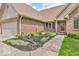 Close-up of a charming brick home's front exterior and landscaped entry at 7113 Lakeside Woods Dr, Indianapolis, IN 46278