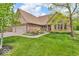 Lovely home with brick facade, three-car garage, and a well-maintained front lawn at 7113 Lakeside Woods Dr, Indianapolis, IN 46278