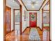 Welcoming entrance hallway boasting sleek hardwood floors and a vibrant red front door at 7113 Lakeside Woods Dr, Indianapolis, IN 46278