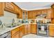 Kitchen featuring tile floors, stainless appliances, granite counters and wooden cabinets at 7113 Lakeside Woods Dr, Indianapolis, IN 46278