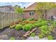 Lush landscaping and garden featuring various plants and stone edging at 7113 Lakeside Woods Dr, Indianapolis, IN 46278