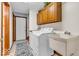 This laundry room includes a utility sink, cabinets, and a washing machine and dryer at 7113 Lakeside Woods Dr, Indianapolis, IN 46278