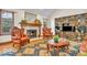 Cozy living room features plush furniture, a decorative fireplace, and views from many windows at 7113 Lakeside Woods Dr, Indianapolis, IN 46278