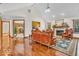 Spacious living area featuring gleaming hardwood floors, a fireplace, and an attached kitchen at 7113 Lakeside Woods Dr, Indianapolis, IN 46278