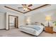 This main bedroom boasts tray ceilings, carpeted floors, and an en suite bathroom with a soaking tub at 7113 Lakeside Woods Dr, Indianapolis, IN 46278