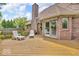 Deck featuring outdoor furniture and a red brick house with a sliding glass door at 7113 Lakeside Woods Dr, Indianapolis, IN 46278