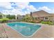 Backyard swimming pool surrounded by a concrete patio and lush landscaping at 7113 Lakeside Woods Dr, Indianapolis, IN 46278