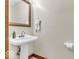 This powder room includes a pedestal sink and neutral paint at 7113 Lakeside Woods Dr, Indianapolis, IN 46278