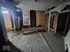 Interior of a dilapidated room, featuring exposed walls, old floors, and boarded windows at 727 W 25Th St, Indianapolis, IN 46208