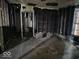 Interior view reveals an empty room with exposed studs and an old, stained window at 727 W 25Th St, Indianapolis, IN 46208