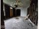 Interior of a room in disrepair, showing exposed framework and deteriorated ceilings at 727 W 25Th St, Indianapolis, IN 46208