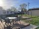 Backyard patio set with a glass top table and chairs on a carpeted area at 760 E Walnut St, Martinsville, IN 46151