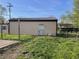 Backyard with a storage shed, green grass, and a clear blue sky at 760 E Walnut St, Martinsville, IN 46151