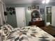 A bedroom featuring a bed, wood dresser with mirror, and decorative wall hangings at 760 E Walnut St, Martinsville, IN 46151