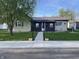 Charming home with well-maintained lawn, metal roof, and inviting walkway at 760 E Walnut St, Martinsville, IN 46151
