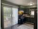 Eat in kitchen with sliding glass door, black appliances and plenty of cabinet space at 760 E Walnut St, Martinsville, IN 46151