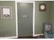 A utility room or laundry room featuring a gray painted door with simple decor and painted green walls at 760 E Walnut St, Martinsville, IN 46151