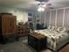 This bedroom has a ceiling fan, desk, decor, and patterned bedding in a comfortable setting at 760 E Walnut St, Martinsville, IN 46151
