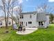 Spacious backyard with a concrete patio, outdoor seating, and lush green lawn at 7775 Hollow Ridge Cir, Indianapolis, IN 46256