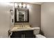 Compact bathroom with modern vanity, framed mirror, updated lighting and standard toilet at 7775 Hollow Ridge Cir, Indianapolis, IN 46256