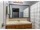 A well-lit bathroom featuring a vanity with mirror and a shower with striped curtain at 7775 Hollow Ridge Cir, Indianapolis, IN 46256