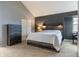 Well-lit bedroom featuring carpet, and wooden accent wall with a stylish bed and bedside lighting at 7775 Hollow Ridge Cir, Indianapolis, IN 46256