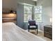 Comfortable bedroom featuring natural light, comfortable chair, and a wooden headboard at 7775 Hollow Ridge Cir, Indianapolis, IN 46256