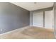Cozy carpeted bedroom featuring closet and white trim at 7775 Hollow Ridge Cir, Indianapolis, IN 46256