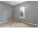 Neutral bedroom with cozy carpet, natural light from the window, and outlets at 7775 Hollow Ridge Cir, Indianapolis, IN 46256