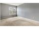 Bright bedroom with window, neutral carpet, and light gray walls at 7775 Hollow Ridge Cir, Indianapolis, IN 46256