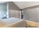 Spacious bedroom with vaulted ceiling, neutral walls, carpet, and access to upper floors at 7775 Hollow Ridge Cir, Indianapolis, IN 46256