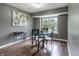 Dining room with a glass table, four chairs, wood flooring, artwork and a window at 7775 Hollow Ridge Cir, Indianapolis, IN 46256