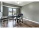 Dining room with a glass table, four chairs, wood flooring, and a view of a pond at 7775 Hollow Ridge Cir, Indianapolis, IN 46256