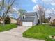 Two-story home featuring an attached garage, well-maintained lawn and mature trees at 7775 Hollow Ridge Cir, Indianapolis, IN 46256