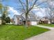 Charming home with an attached garage and a well-maintained lawn near a scenic neighborhood pond at 7775 Hollow Ridge Cir, Indianapolis, IN 46256