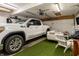 Finished garage space with epoxy floors, overhead lighting, and space for parking and relaxing at 7775 Hollow Ridge Cir, Indianapolis, IN 46256