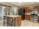 Well-equipped kitchen with stainless steel appliances, tile floors, and an island with bar seating at 7775 Hollow Ridge Cir, Indianapolis, IN 46256