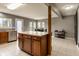 Open kitchen with tiled floors, wooden cabinets, an island, and an adjacent dining area at 7775 Hollow Ridge Cir, Indianapolis, IN 46256