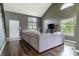 Inviting living room with vaulted ceilings, hardwood floors, and large windows providing natural light at 7775 Hollow Ridge Cir, Indianapolis, IN 46256