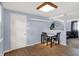 Simple dining area featuring a small table, vinyl floors, blue walls, and a white door at 7915 Broadview Dr, Indianapolis, IN 46227