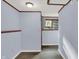 Hallway with light blue walls, plank floors, natural light from a window at the end of the hall at 7915 Broadview Dr, Indianapolis, IN 46227