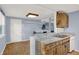 Open kitchen with breakfast bar, wood cabinets, and blue walls connected to dining area at 7915 Broadview Dr, Indianapolis, IN 46227