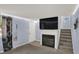 Cozy living room features fireplace with tv and stair access at 7915 Broadview Dr, Indianapolis, IN 46227