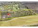 An aerial view displays the landscape of the lot with mature trees in a desirable location at 8327 S County Road 825 E, Plainfield, IN 46168