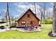 Rear view of the home featuring an outdoor patio with stone pavers and a backyard fire pit at 8327 S County Road 825 E, Plainfield, IN 46168