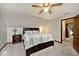 Bedroom featuring a large bed, side tables, and new gray carpet at 8327 S County Road 825 E, Plainfield, IN 46168