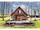 Charming A-frame home featuring a spacious wooden deck, balcony and beautifully landscaped yard with mature trees at 8327 S County Road 825 E, Plainfield, IN 46168